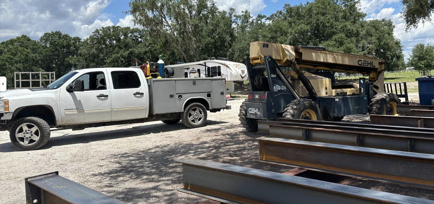 Service truck and heavy equipment on site